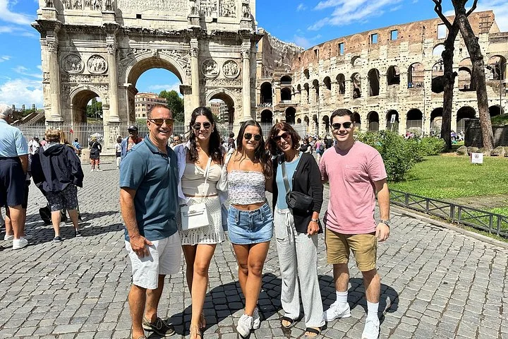 Visitors beside the Arch of Constantine and Colosseum