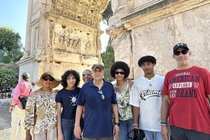 Visitors beneath the carved Arch of Titus