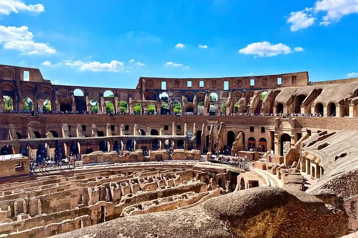 Colosseum interior beneath vivid blue sky