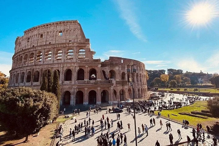 Bright Colosseum exterior above a busy sunlit square