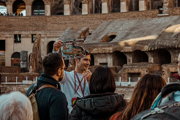 Guide holding a reconstruction sheet on the Colosseum arena route