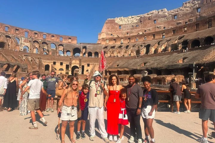 Guide and visitors standing on the Colosseum arena platform