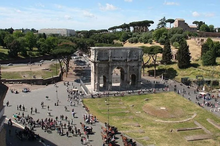 Arch of Constantine and green lawns seen from the Colosseum