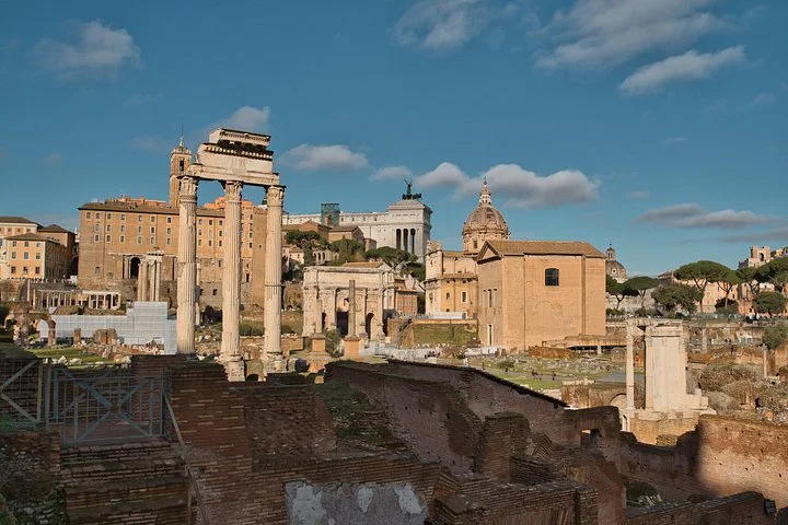 Ancient columns and temples stand among the Roman Forum's ruins.