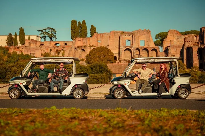 Two golf carts outside the ancient Palatine palace walls