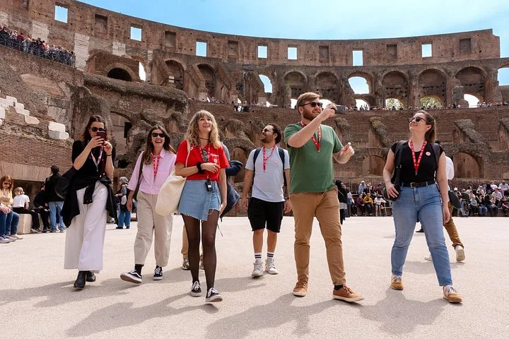 Guide leading visitors across the Colosseum arena platform