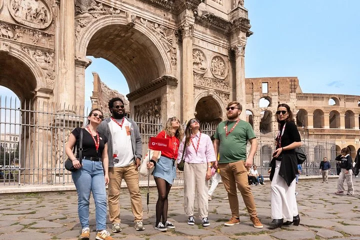 Guide and visitors beside the Arch of Constantine