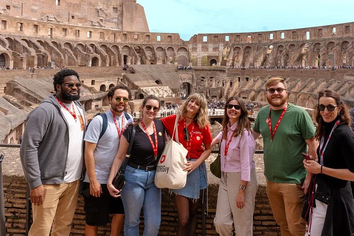 Visitors posing at a main-level Colosseum railing