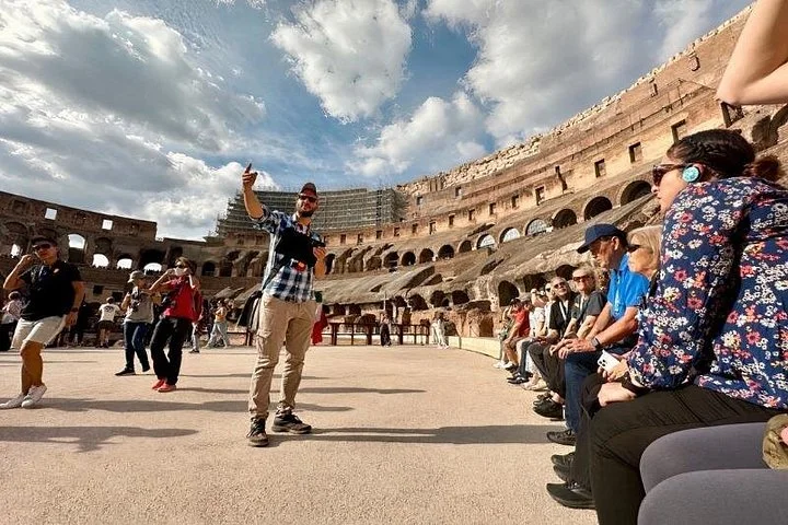 Guide speaking to visitors on the arena platform