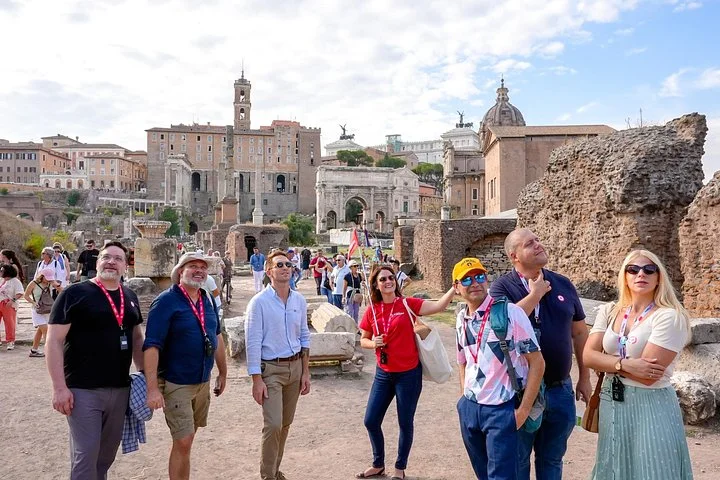 Guide and visitors walking through the Roman Forum