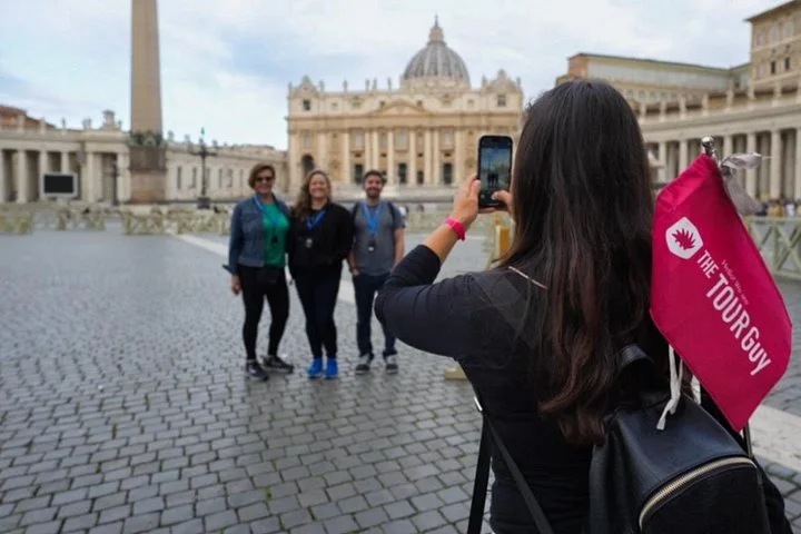 Visitors taking a photograph in St Peter's Square