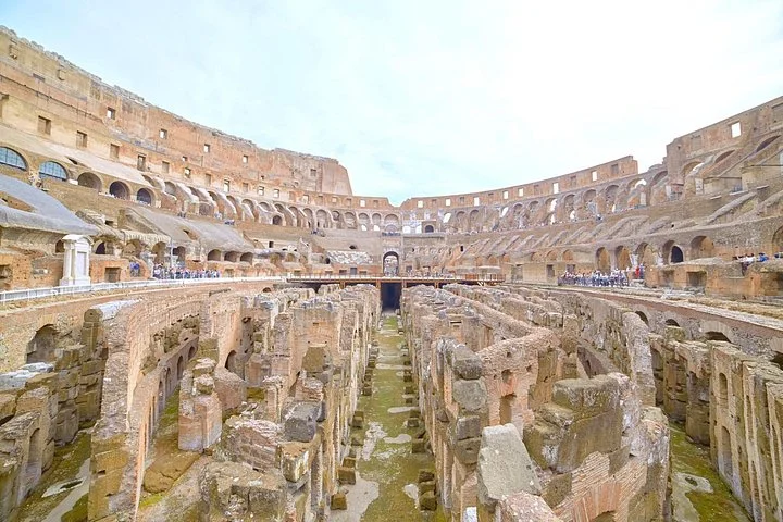 The Colosseum's exposed hypogeum is seen below the surrounding tiers.