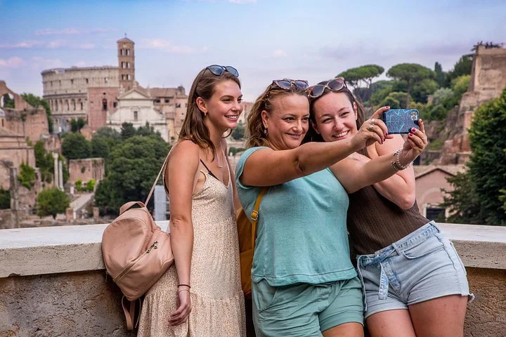 Three visitors taking a selfie above the Roman Forum