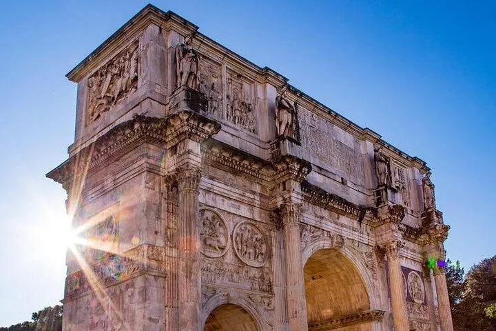 Arch of Constantine beside the Colosseum in bright sunlight