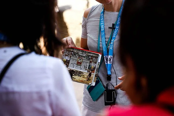 Guide holding an illustrated reconstruction during a tour