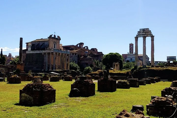 Sunlit Roman Forum ruins and temple columns