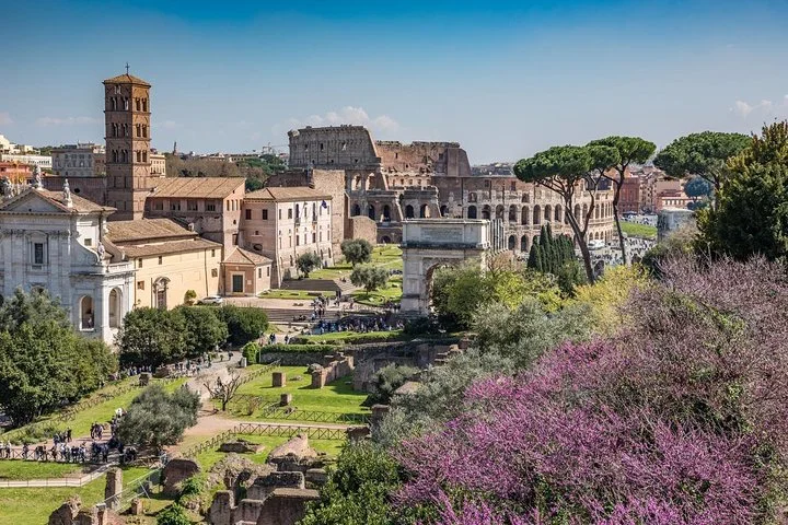 Roman Forum panorama with flowering trees and the Colosseum behind
