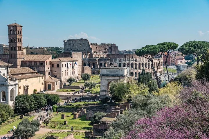 Roman Forum panorama with flowering trees and the Colosseum in the distance