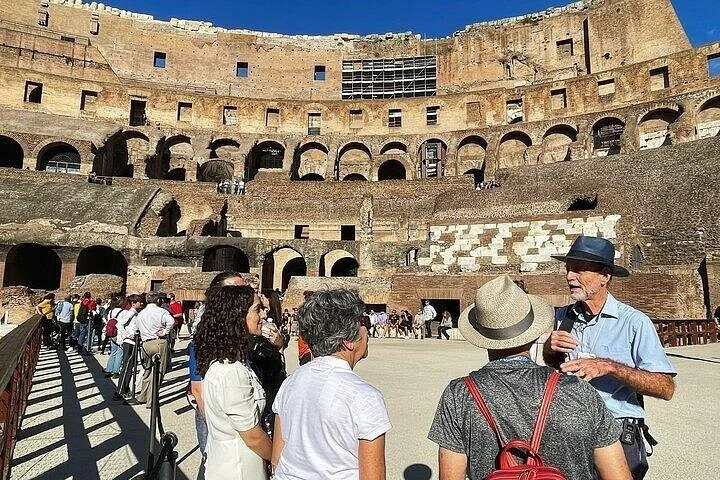 Guide speaking with visitors on the Colosseum arena platform