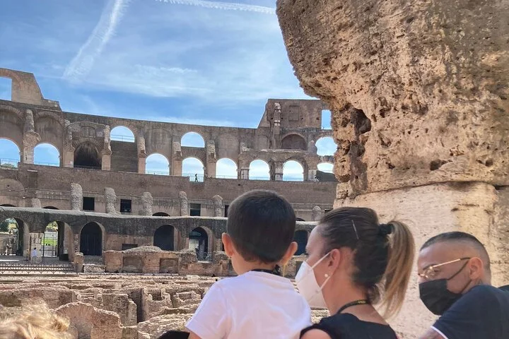 Adult and child looking into the Colosseum from a main-level arcade