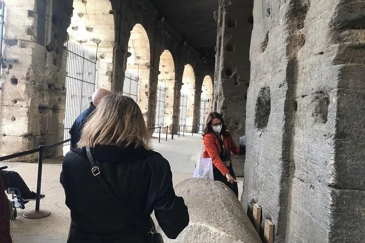 Visitors walking through a main Colosseum arcade