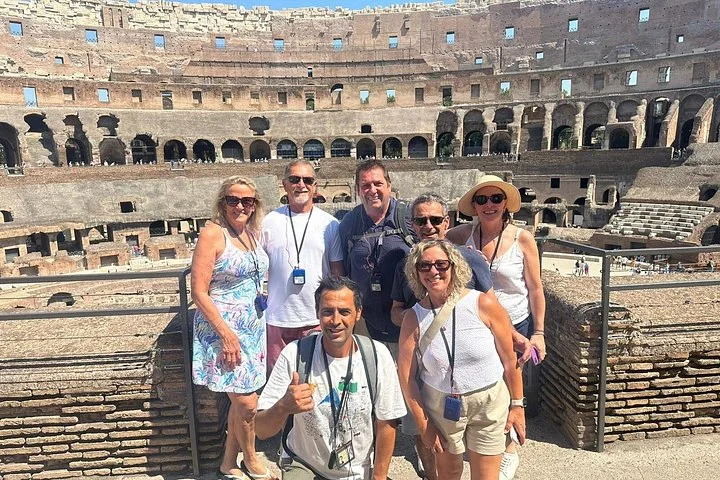 Visitors posing at a stone-railed Colosseum overlook