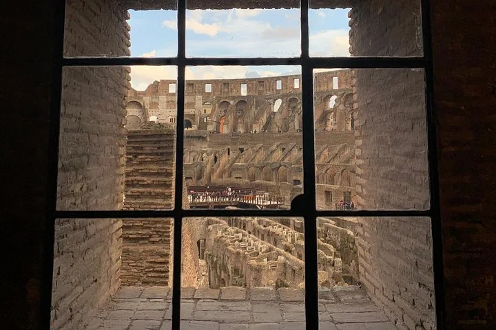 Colosseum interior framed by a window in a shaded gallery