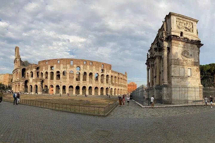 Colosseum and Arch of Constantine beneath a cloudy sky