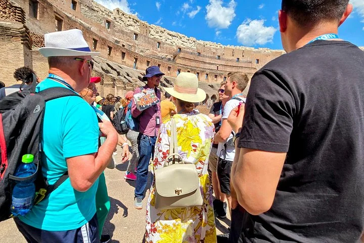 Guide speaking with visitors on the Colosseum arena platform