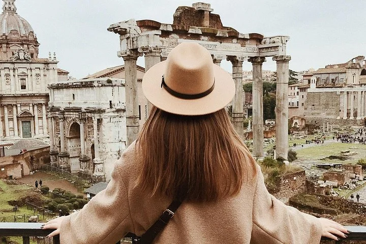 Visitor in a sunhat looking across the Roman Forum