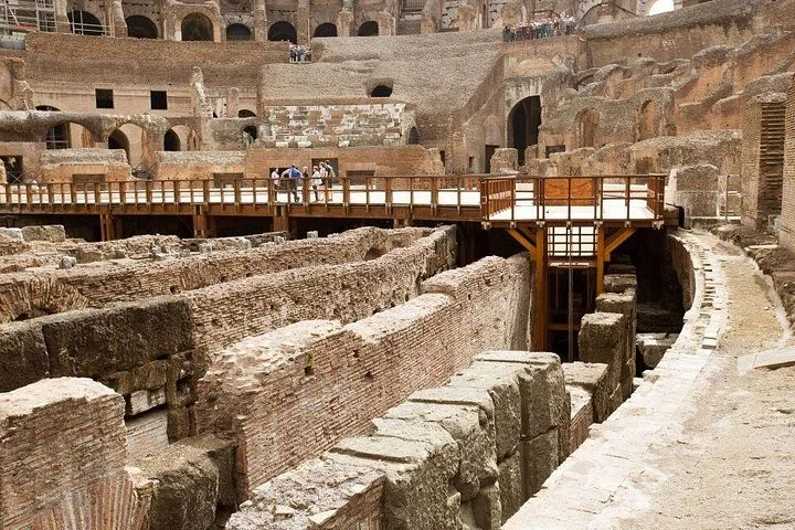 Brick walls of the hypogeum lie below the Colosseum arena platform.