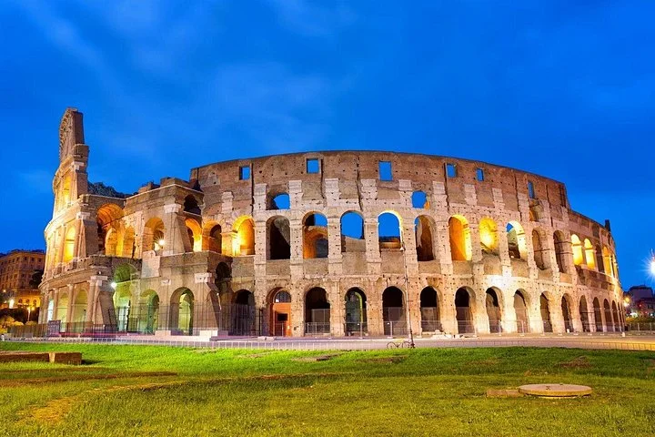 Illuminated Colosseum exterior at blue hour