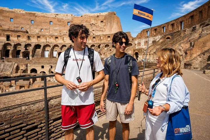 Guide and visitors at a stone-railed Colosseum overlook