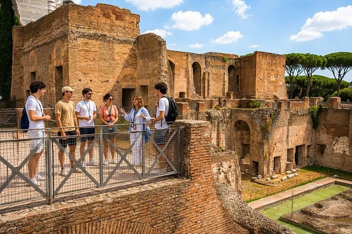 Guide and visitors above ancient Palatine palace walls
