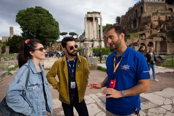Guide and two visitors among Roman Forum ruins