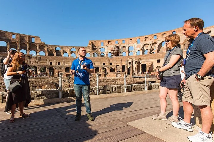 Guide speaking with visitors on the Colosseum arena platform