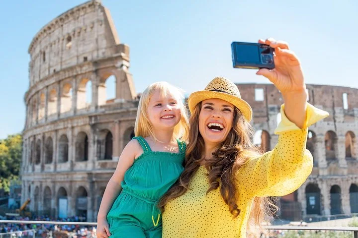 Adult and child taking a selfie outside the Colosseum