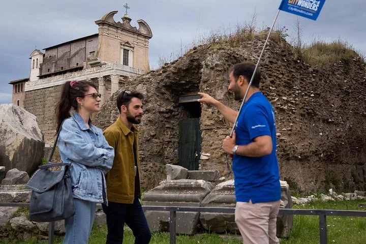 Guide and visitors among Roman Forum ruins