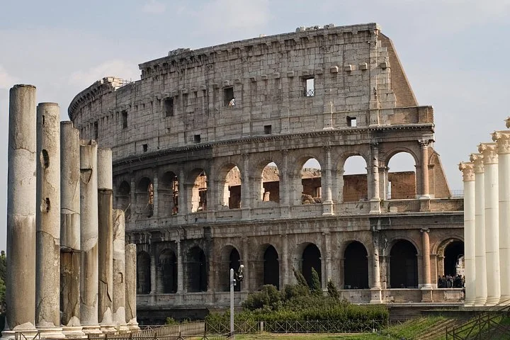 Colosseum exterior framed by ancient columns