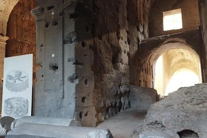 Ancient masonry and a sunlit arch in the Colosseum main galleries