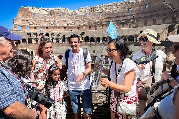 A guide speaking with visitors inside the Colosseum
