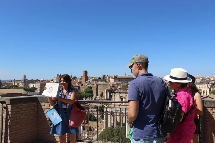 Guide and visitors overlooking the Roman Forum