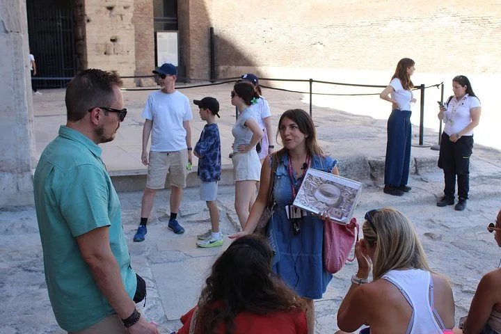 A guide showing an illustration beneath Colosseum arches