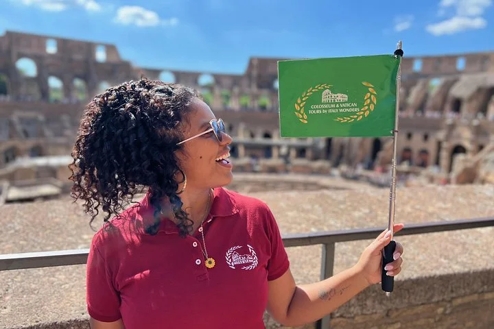 An Italy Wonders guide stands at a Colosseum visitor overlook.