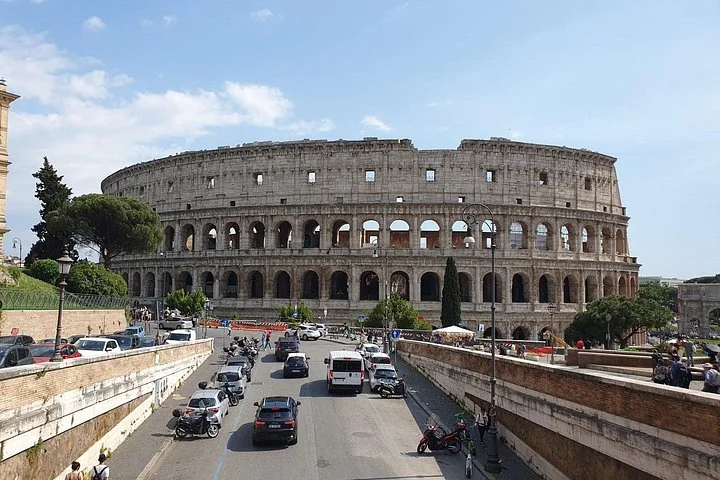 The Colosseum at the end of a Rome street