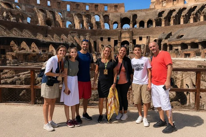 Visitors posing beside the arena-floor railing