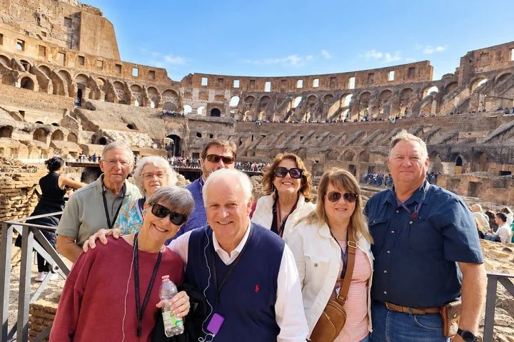 Visitors posing at a Colosseum viewing railing