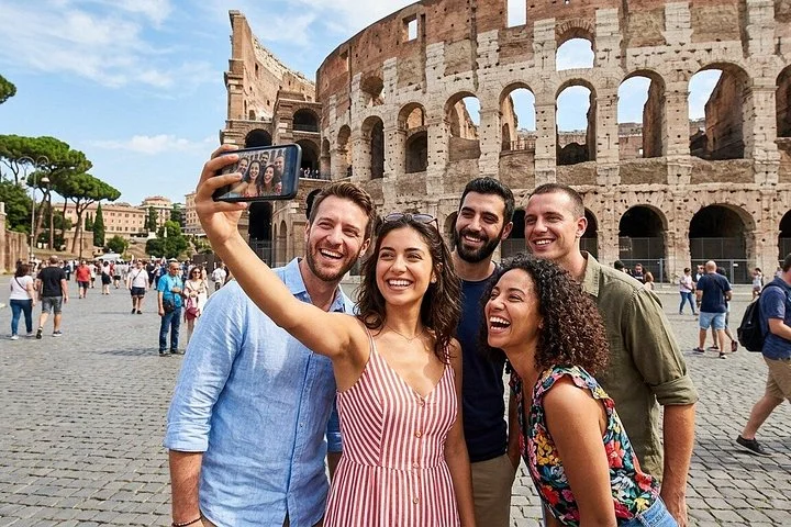 Visitors taking a group selfie outside the Colosseum