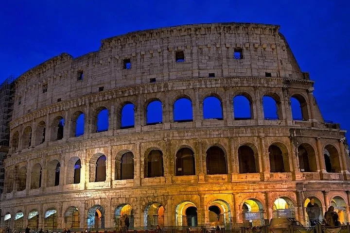 The illuminated Colosseum at dusk