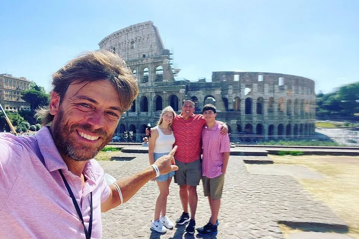A guide and visitors outside the Colosseum